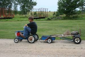 Jayton pedals his pint-sized New Holland tractor on the family farm.