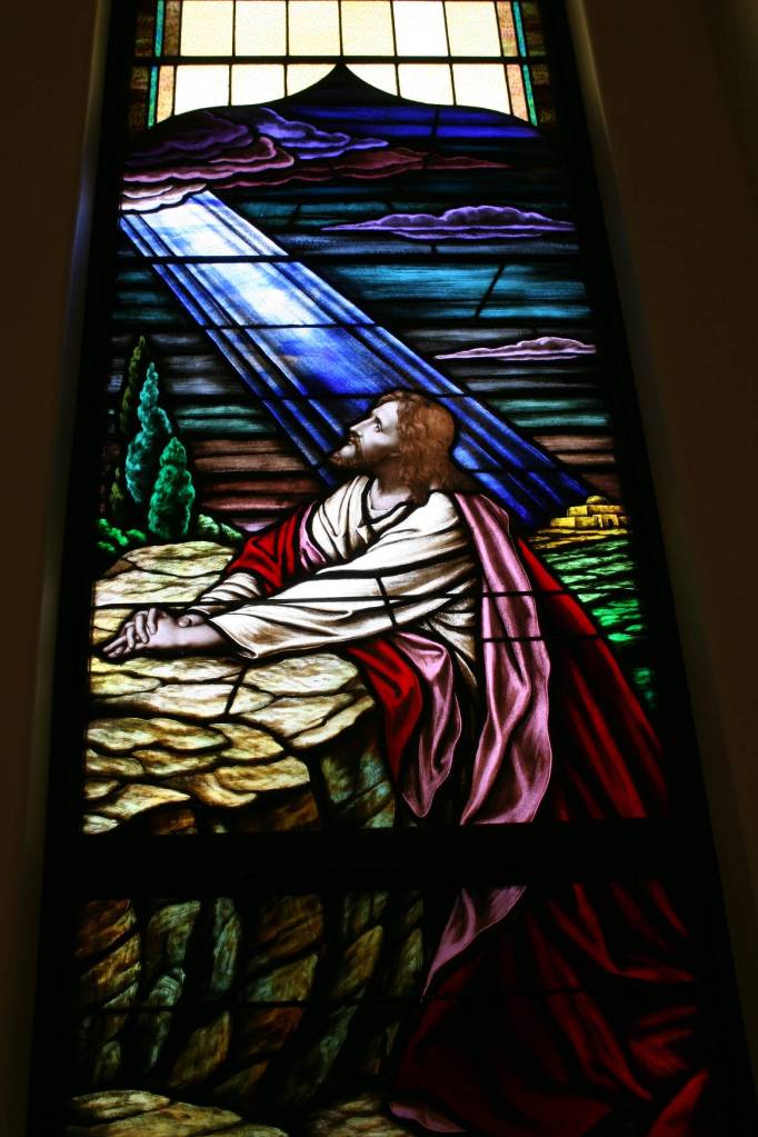Another window shows Jesus praying in the Garden of Gethsemane.