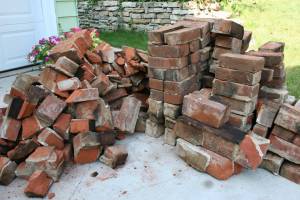Two brick piles, one for fill, the other to recycle, are accumulating on our driveway. Anyone want brick?