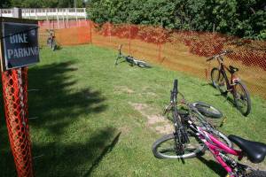 A sign indicates that this fenced parking space is reserved for bikes only near the Kenyon Municipal Swimming Pool.