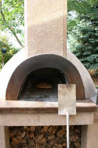 The pizzas are baked for several minutes in this 700-degree brick oven.
