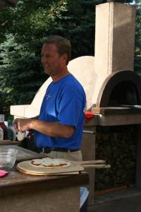 Dan prepares a pizza crust at his backyard work station.