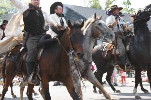I shot this image of the James-Younger gang riding their horses along the parade route. Because my shutter speed wasn't set fast enough for the action, the photo is a bit blurry. But I like it that way.