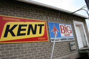 Colorful advertising contrasts with the original brick building at the Nicollet Farmers Exchange Co.