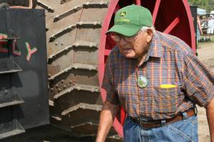I like the determined look on this retired farmer's face as he passes a gigantic Rumely steam engine..