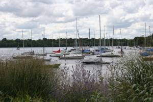 Sailboats sit upon the waters of Lake Harriet.