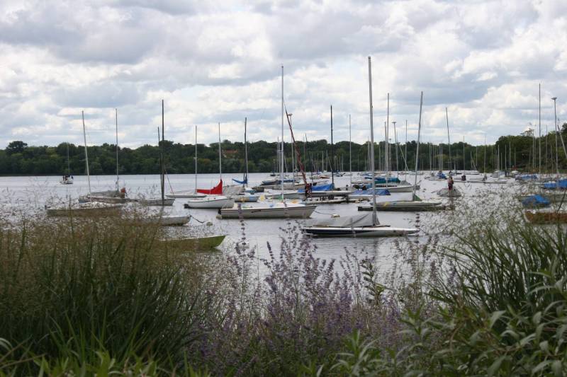 Sailboats sit upon the waters of Lake Harriet.