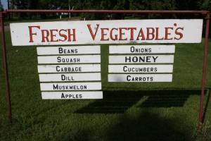 A homemade sign indicates the produce available.
