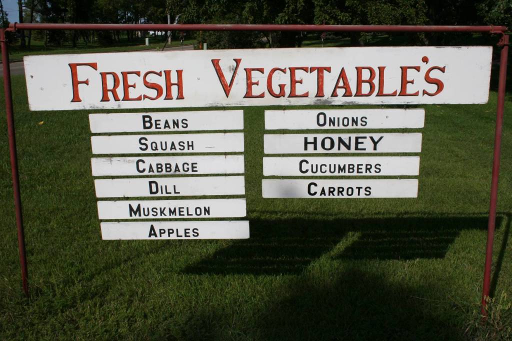 A homemade sign indicates the produce available.