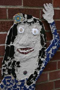 A face of Mexico depicted in a mosaic on the side of the school building.