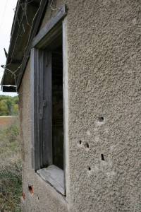 This bullet-ridden "home" will need new windows. But you can get a federal energy tax credit to offset the cost.