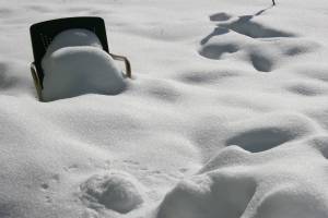 Lawn chair buried in snow