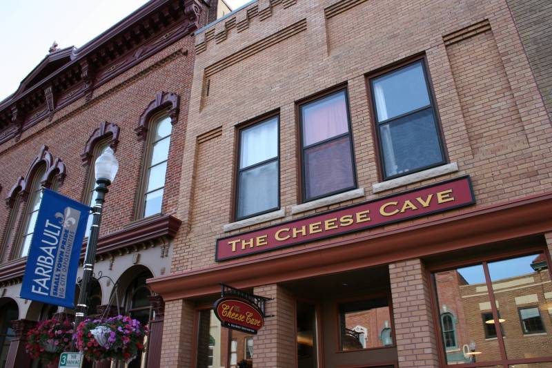 The Cheese Cave is housed in a beautifully-restored building in historic downtown Faribault. The interior, with an arched ceiling and sandstone-colored walls, mimics the caves where Faribault Dairy ages its cheeses.