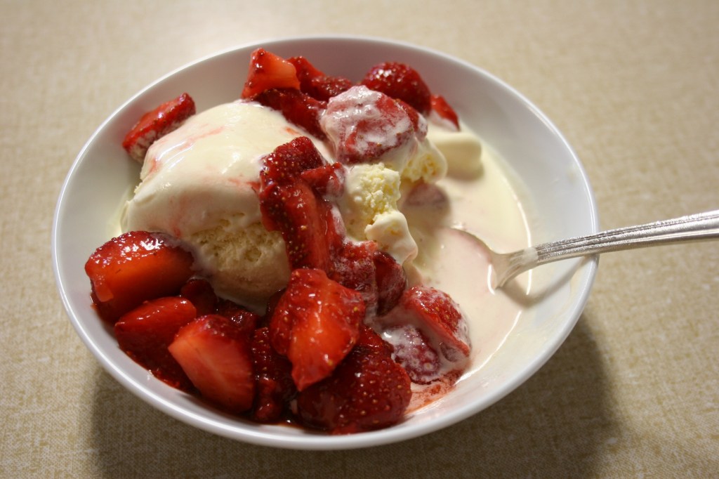 The Moland folks serve a generous amount of strawberries with two scoops of ice cream.
