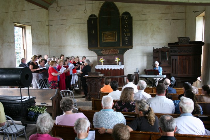 During a worship service filled with music, choir and congregational members sing in Norwegian, "Ja, vi elsker."
