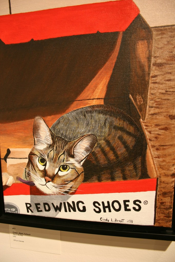 Painting of cat in a Red Wind shoebox.
