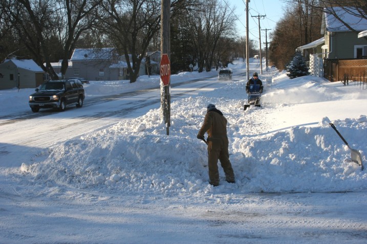 My husband shovels the end of the sidewalk while our neighbor works toward him with the snowblower. What a great neighbor.