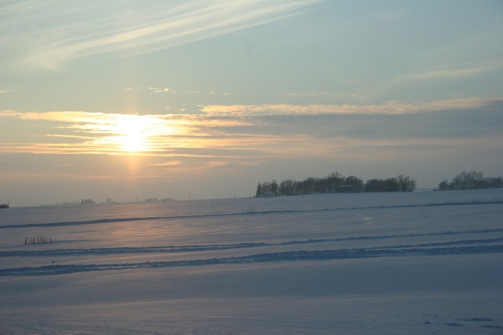 The sun begins setting over the prairie