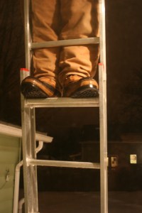 climbing ladder to remove ice