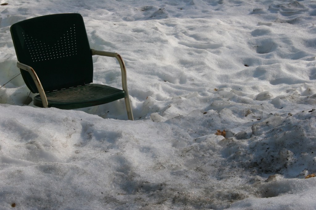 Vintage lawn chair in snow.