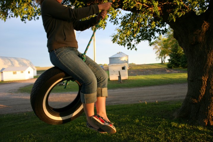 In this June 2011 photo, my daughter swings on a tire swing on my childhood farm.