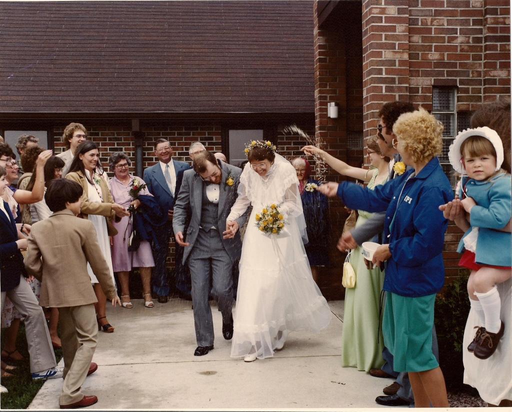 Wedding guests toss rice at Randy and me as we exit St. John's Lutheran Church following our May 15, 1982, wedding.
