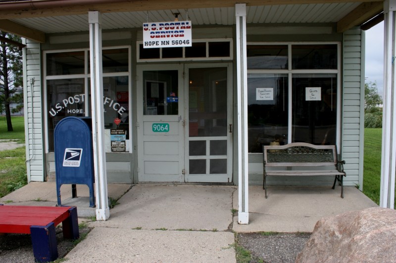 Take in the details: the red and blue bench, the double front doors, the rock out front...