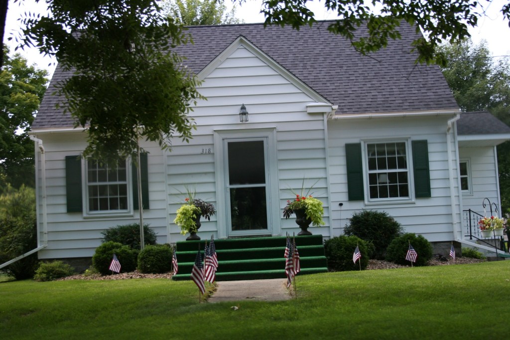 Obama, flags by house