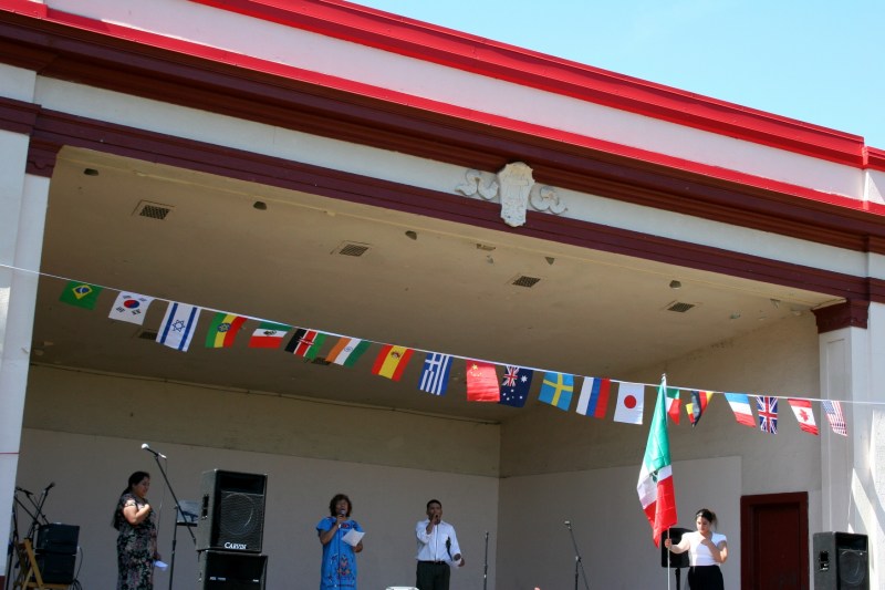Several Latinos lead in singing of Mexico's national anthem last September during the International Festival Faribault at Faribault's Central Park.