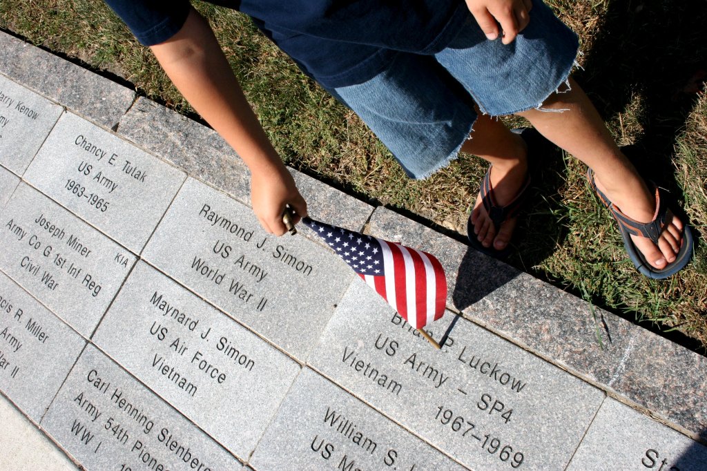 A young boy peruses the pavers honoring veterans at the Rice County Veterans Memorial in Faribault.