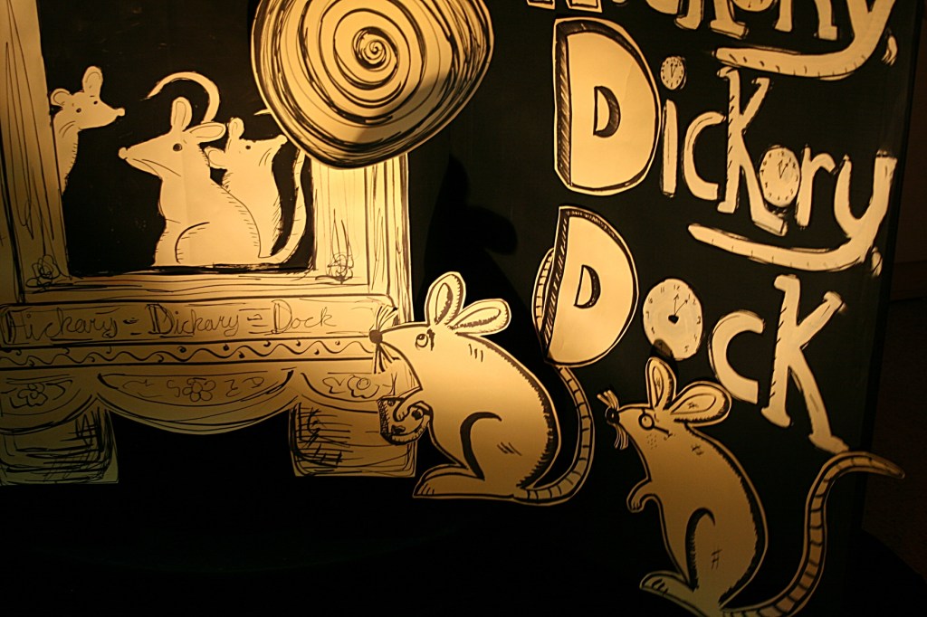 A close-up of art in the Hickory, dickory, dock rhyme.