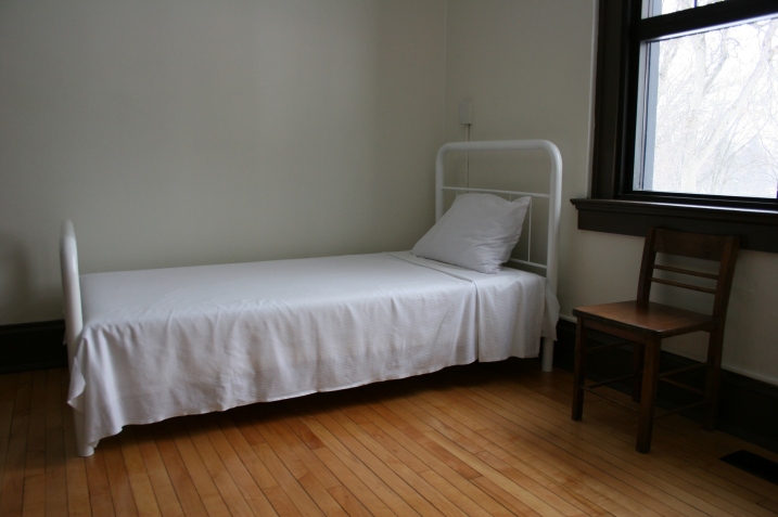 The boys' bedrooms are stark, devoid of anything homey. This small room slept three.