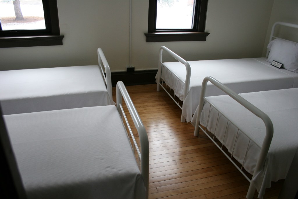 Beds were packed tight into sparse bedrooms in the cottage.