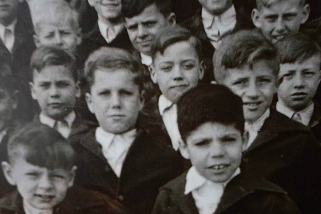 A photo of some of the school's residents on exhibit in Cottage 11, which housed boys ages 6 - 13.