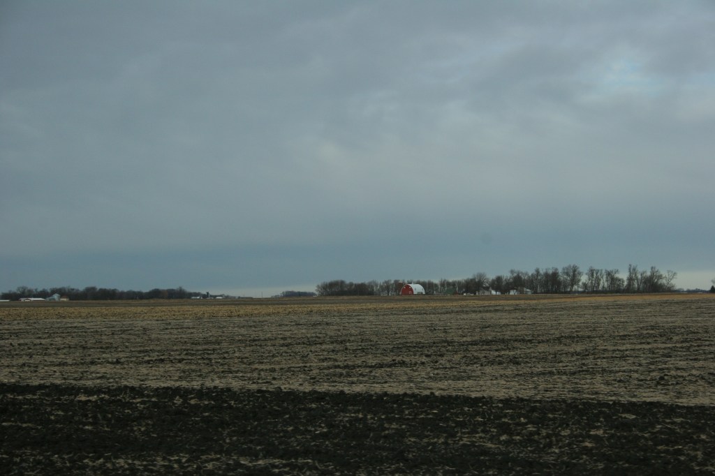 Red, barn in distance