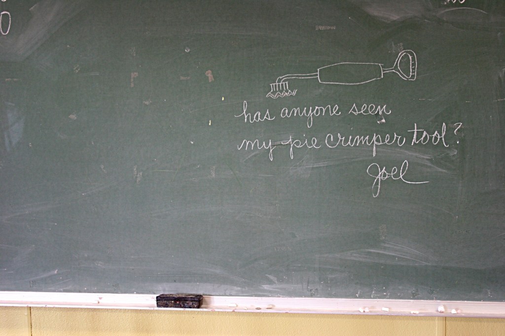 Clay, writing on blackboard
