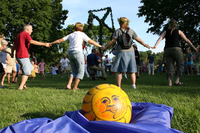 Dancing around the maypole with a sun ball, from an earlier game, resting nearby.