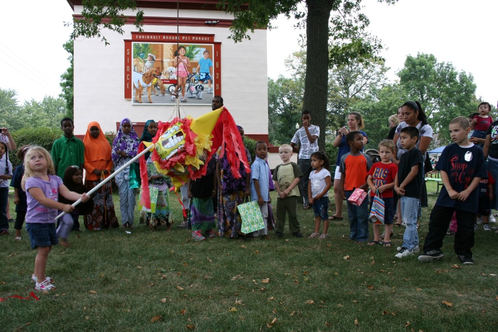 Happy children all focused on the same goal: breaking the pinata.