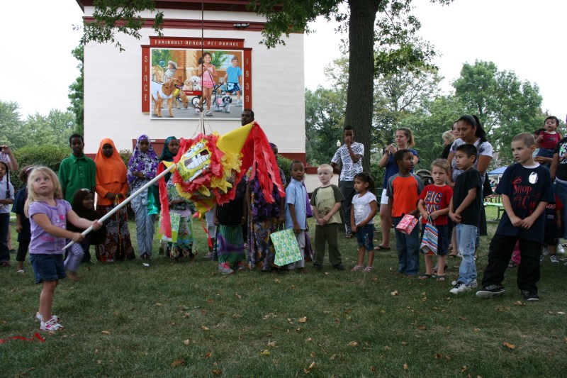 Happy children all focused on the same goal: breaking the pinata.