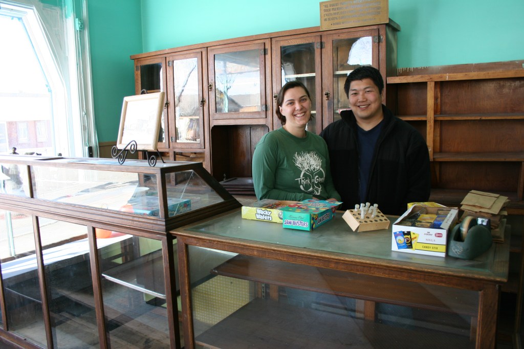 David and Michelle posed behind the original candy counter last fall. Michelle has sweet memories of coming here for candy as a child. Minnesota Prairie Roots file photo.