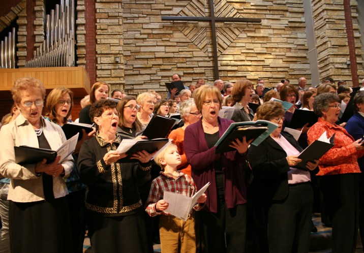 Concert, little boy in mass choir looking up