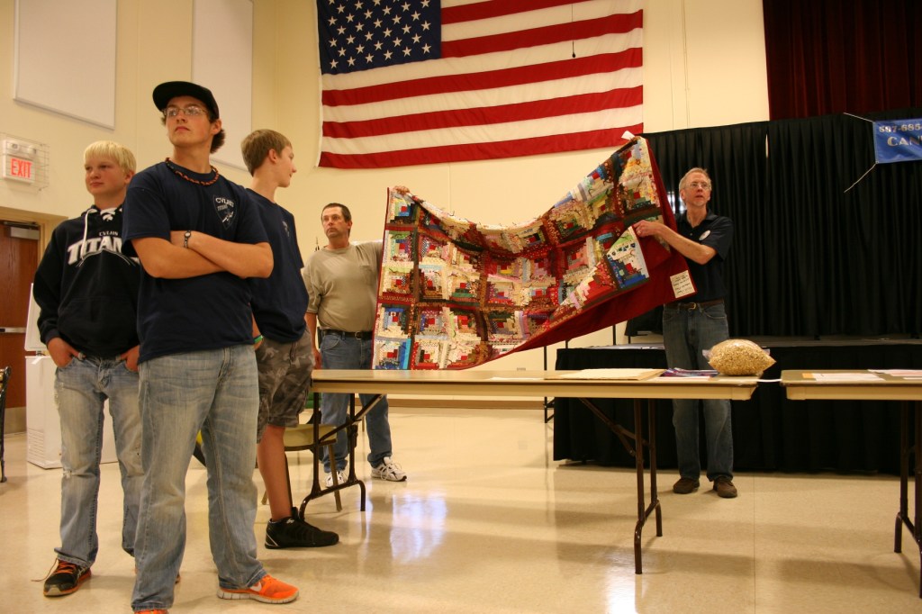 Auctioning of beautiful pieced quilt at the CVLHS live auction.