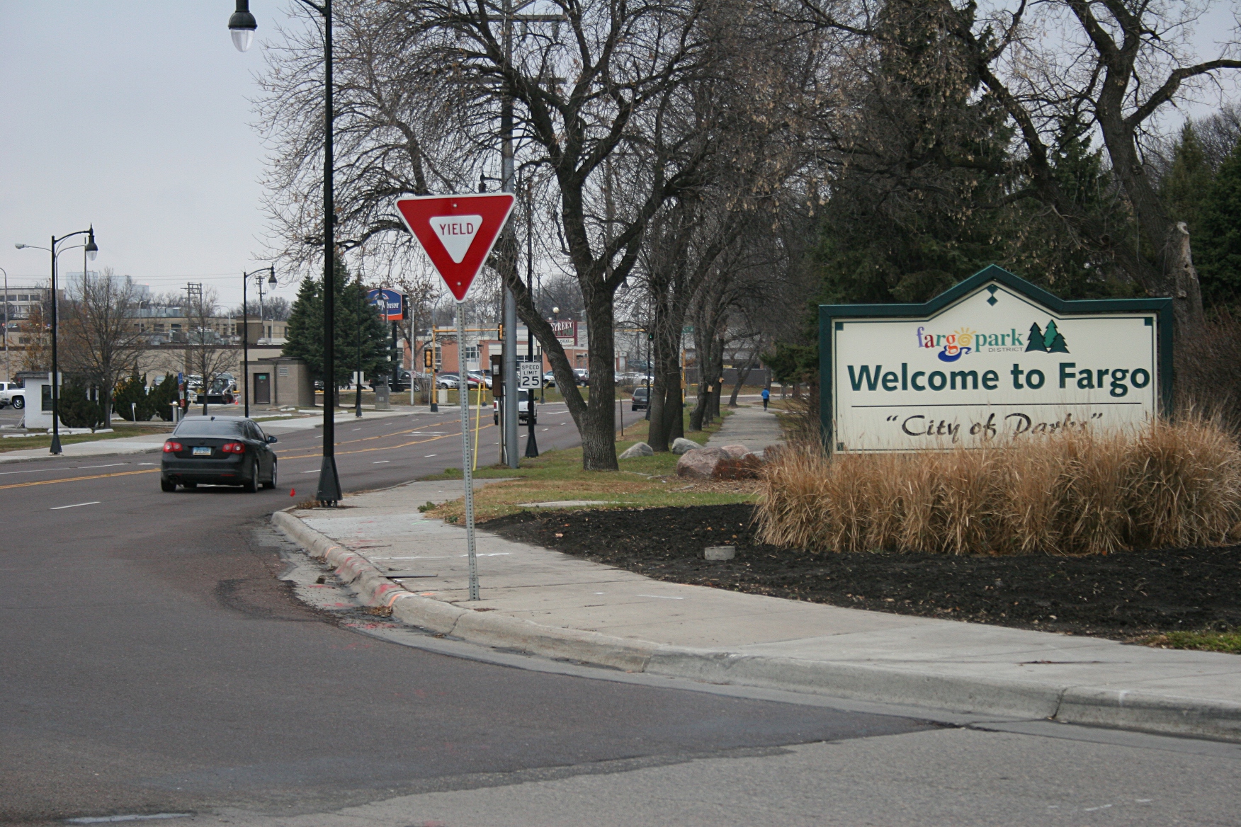 A sign along a city street welcomes us to Fargo, North Dakota, from Moorhead, Minnesota, just across the Red River.
