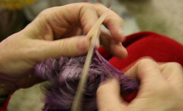 Yarn flies across the needles in Nyla's crafty hands.
