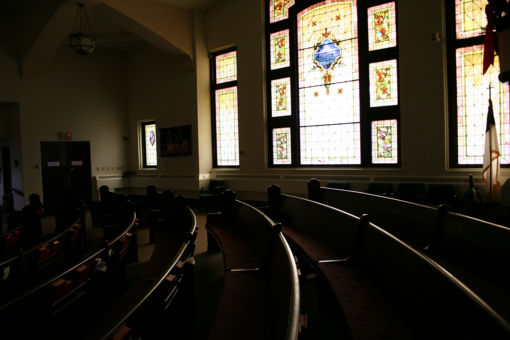 A snippet of the pews and beautiful stained glass window.