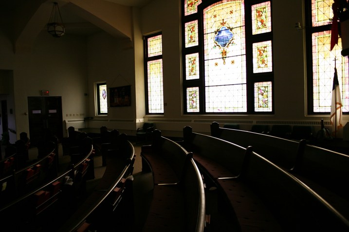 A snippet of the pews and beautiful stained glass window.
