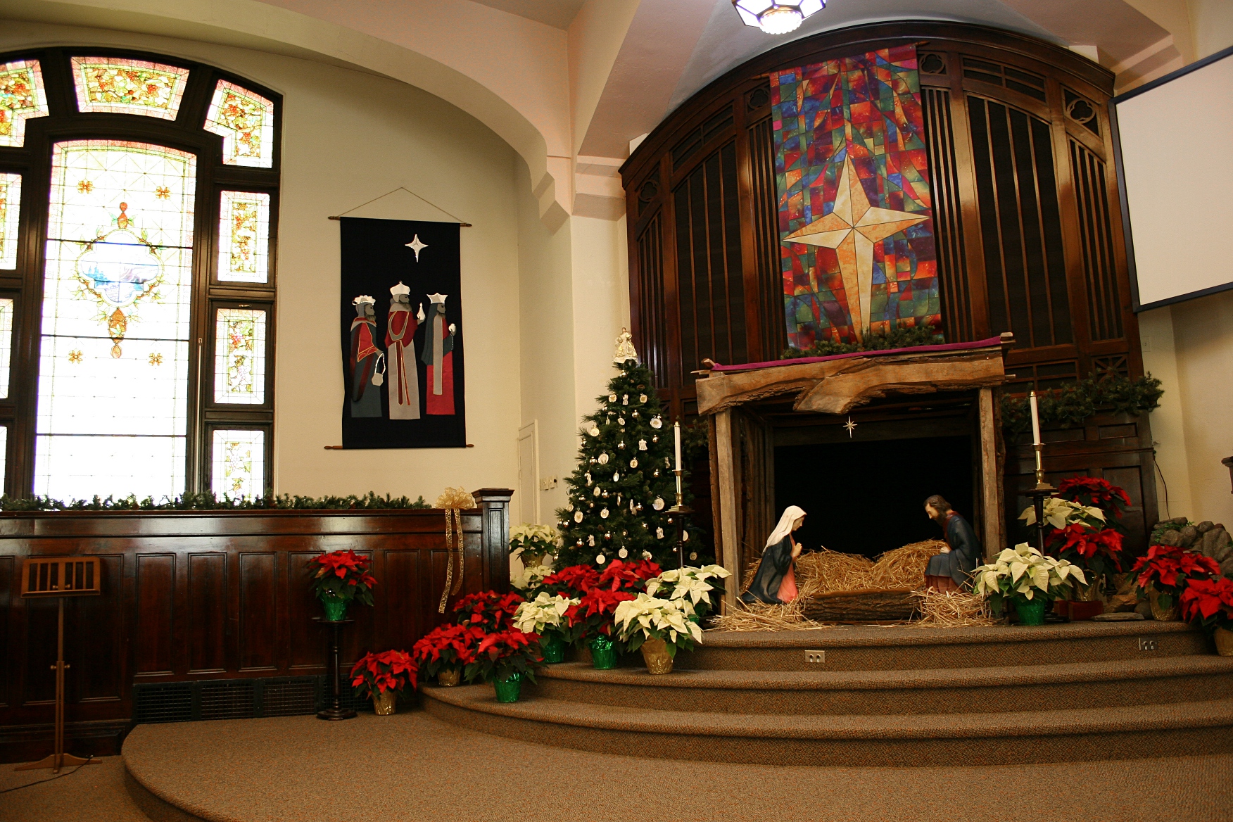 Focusing on the altar area and the eastern stained glass window.