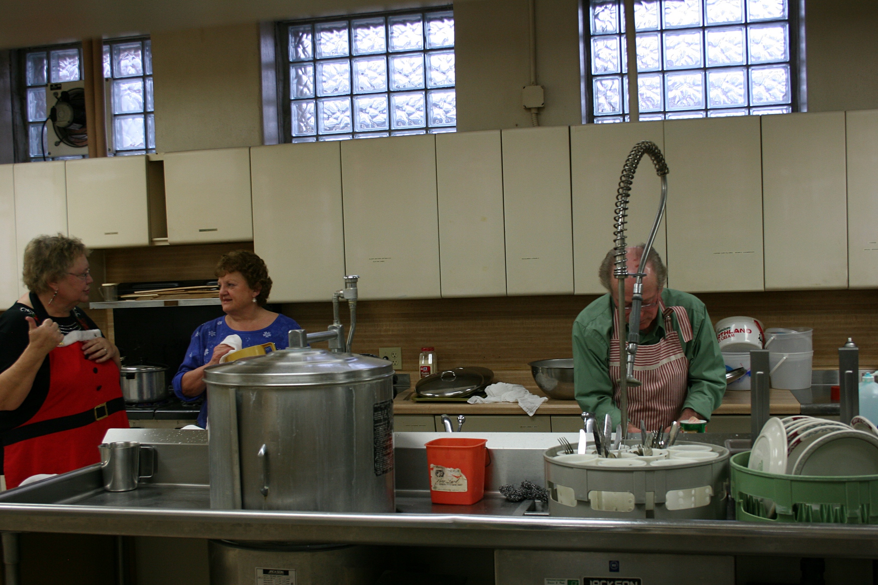 In the kitchen, a team of workers tended the food and washed the dishes, etc.