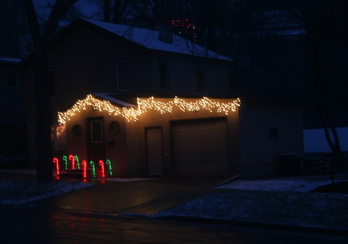 My neighbor's house glows in the fresh snow.