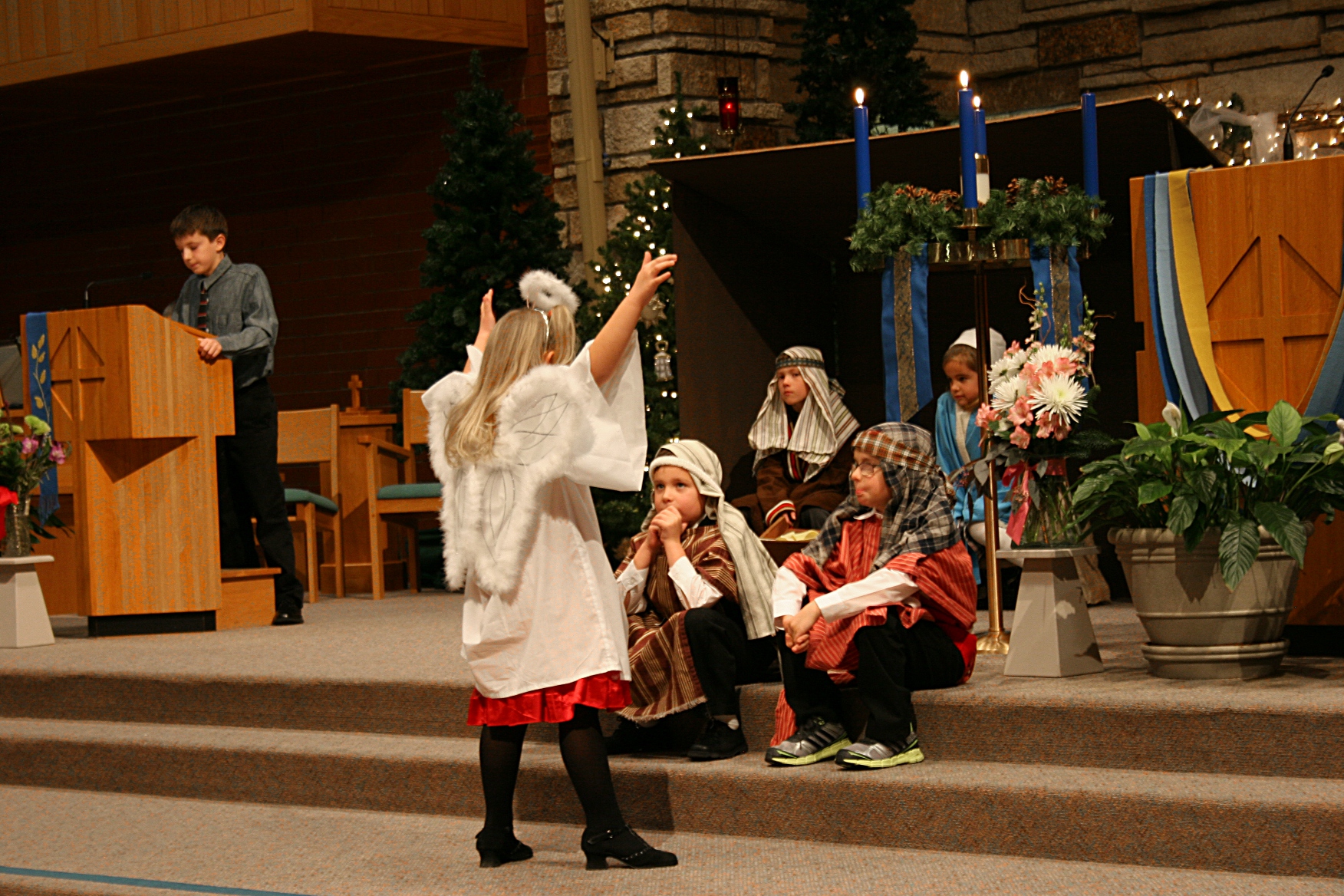 An angel proclaims the news of Christ's birth.